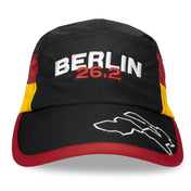 Front view of Run The World Berlin 2026 performance running hat with black crown and red brim